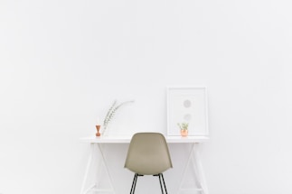 A calm workspace with Japandi-inspired decor featuring natural wood, soft beige tones, and a small plant on the desk.