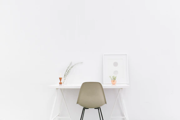 A calm, minimalist workspace with soft natural light and a small plant, reflecting mindfulness training environment.
