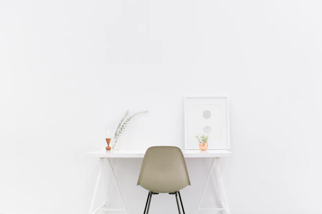 A serene, minimalist workspace with a deep slate blue wall and soft parchment accents, reflecting calm focus and clarity.