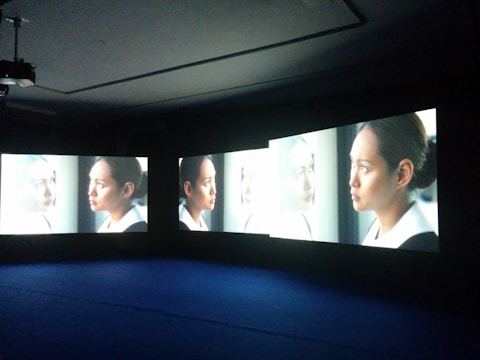 A detective analyzing surveillance footage on multiple screens.