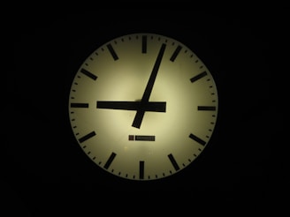 A sleek animated clock face with softly glowing hands ticking forward, symbolizing anticipation.