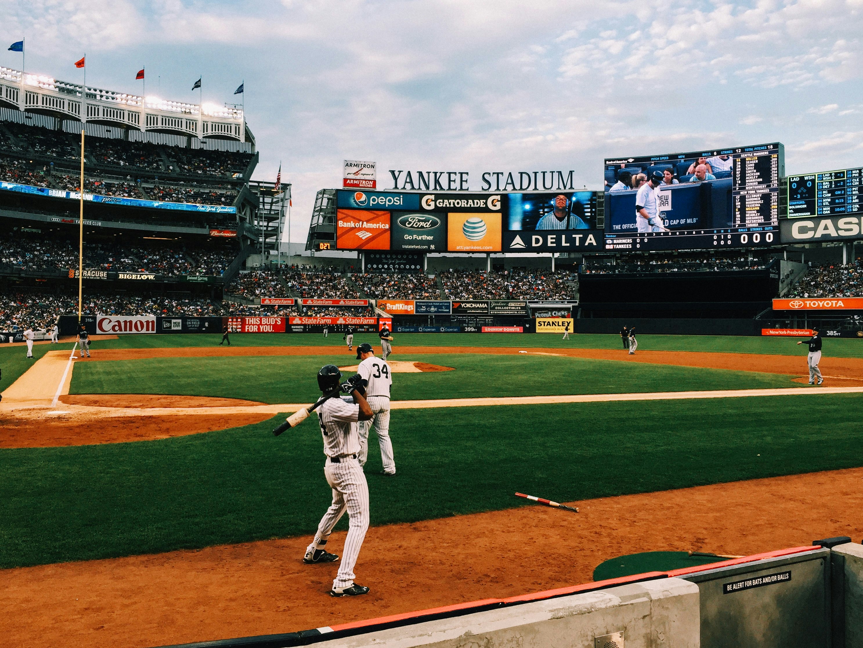 baseball players playing on field during daytime