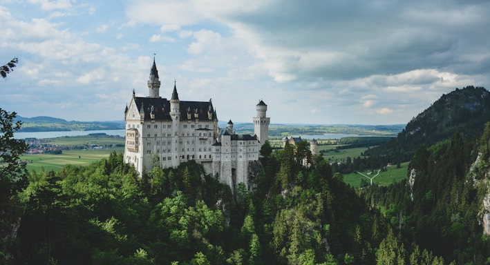 white concrete castle in green field