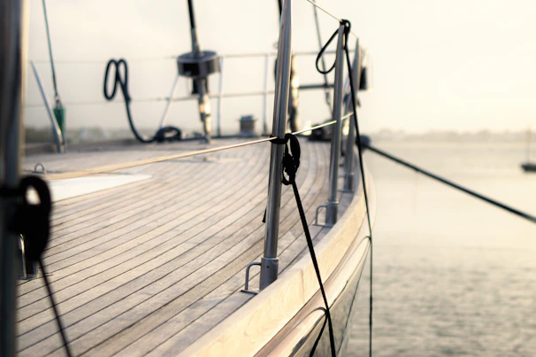 Close-up of a sleek yacht deck with polished wood and stainless steel details