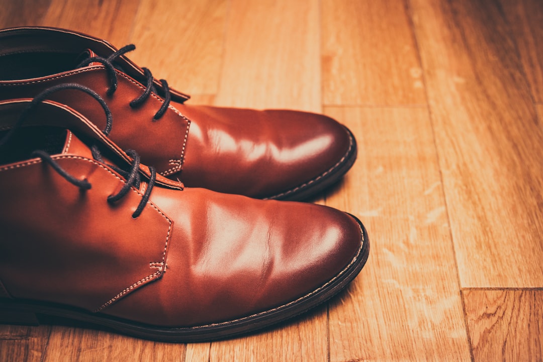 pair of brown leather lace-up boots, Brown leather boots on a wood floor