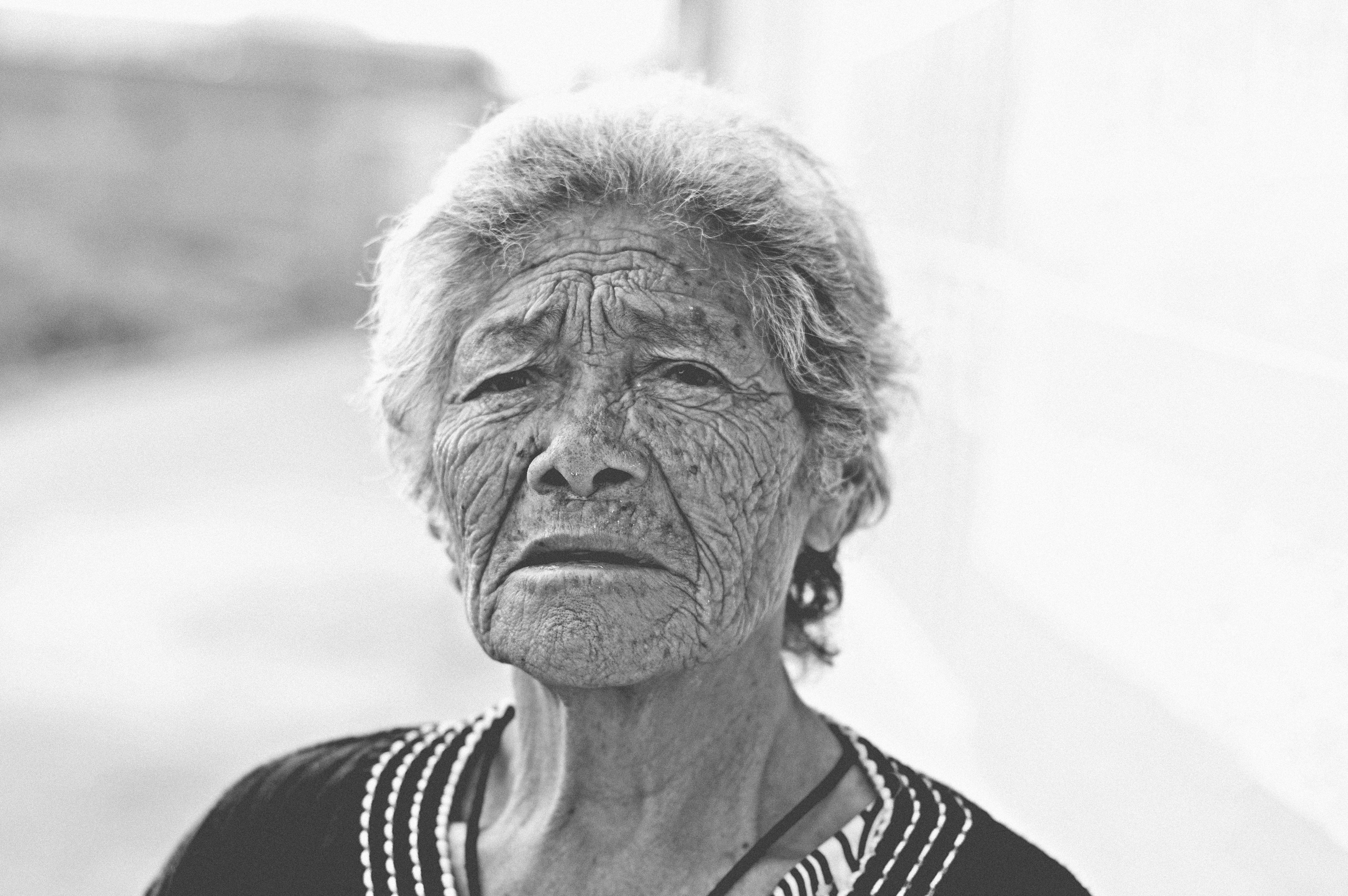 An older Asian woman looking at the camera.