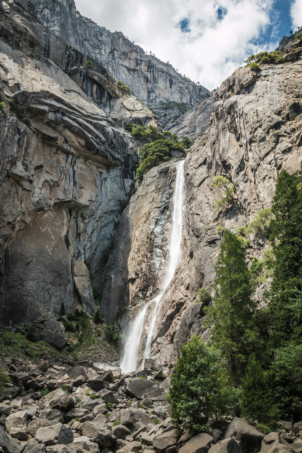 waterfalls under white clouds