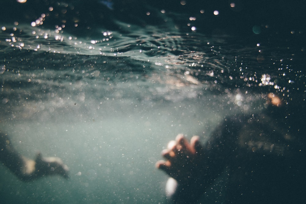 underwater photo of person wearing black shirt