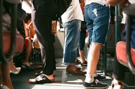 group of person sitting and standing inside the vehicle