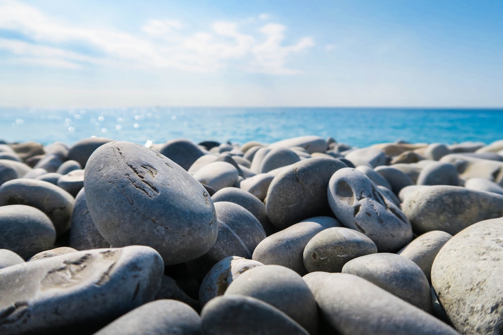 A closeup view of smooth round rocks by the ocean.