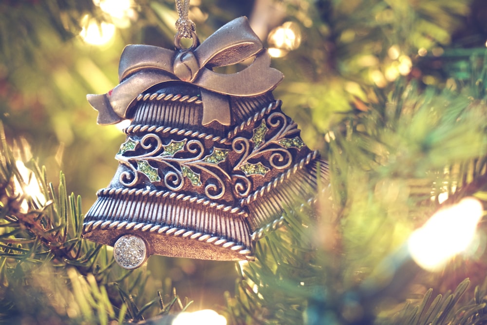 brown bell hanging on christmas tree