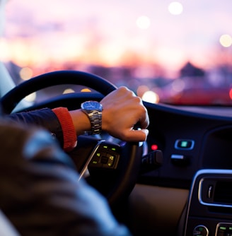 man driving a car wearing wrist watch