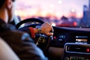 man driving a car wearing wrist watch