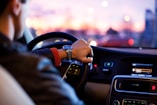 man driving a car wearing wrist watch