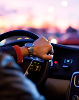 man driving a car wearing wrist watch