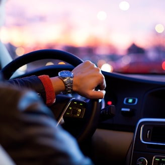 man driving a car wearing wrist watch