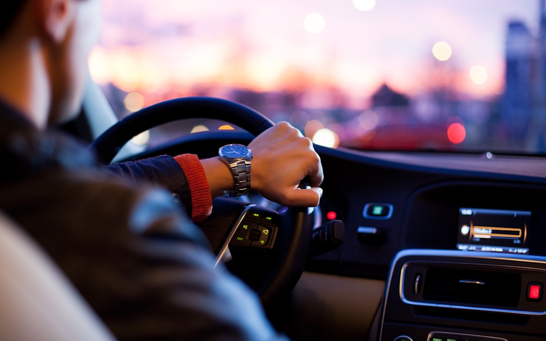 man driving a car wearing wrist watch