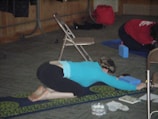 An instructor demonstrating mindful birthing positions to a small class.
