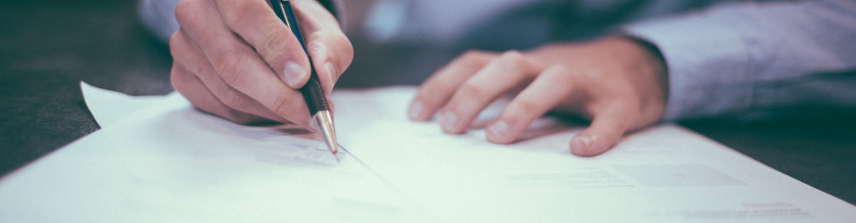 man writing on paper