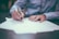 man writing on paper