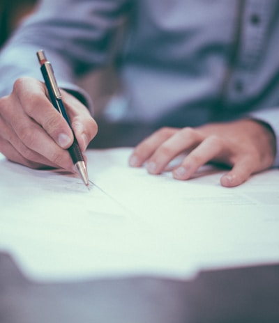 man writing on paper