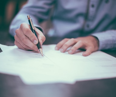 man writing on paper