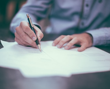 man writing on paper