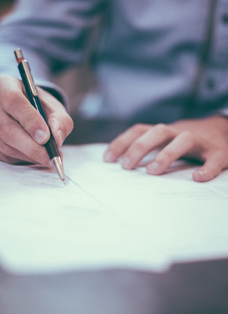 man writing on paper