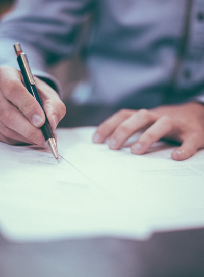 man writing on paper