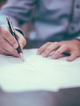 man writing on paper