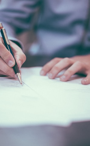 man writing on paper