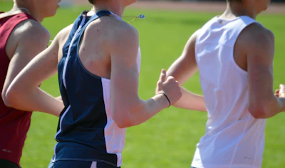 Students jogging together on the college track early morning, showcasing fitness and camaraderie.