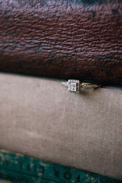 A professional reviewing diamond specifications on a tablet with a luxury office background.