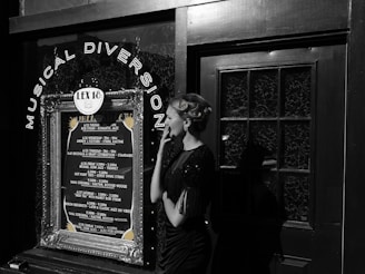 A woman in vintage attire and styled hair stands outside a venue with a decoration sign that reads 'Musical Diversion'. The marquee lists various jazz performances and dates. The scene combines elements of retro fashion with a music theme.