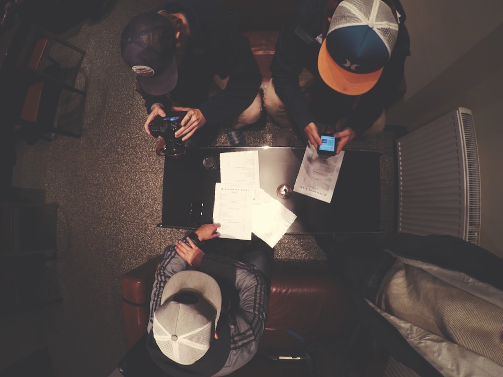 top view of three men sits near radiator heater