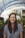 woman smiling while standing in garden