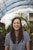 woman smiling while standing in garden