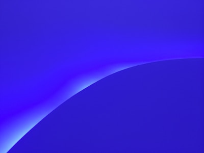 Minimalist composition of smooth, curved lines inspired by ocean waves in deep indigo.