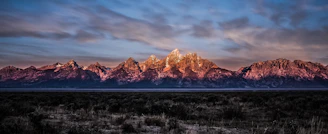 brown rock formations under cloudy sky