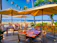 A sleek, modern restaurant website homepage with tropical Caribbean accents.
