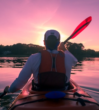 man riding on kayak