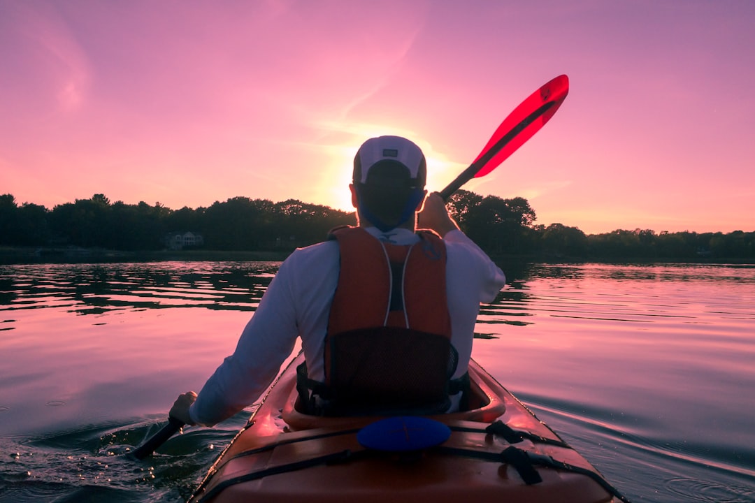man riding on kayak, Rowing into the sunset