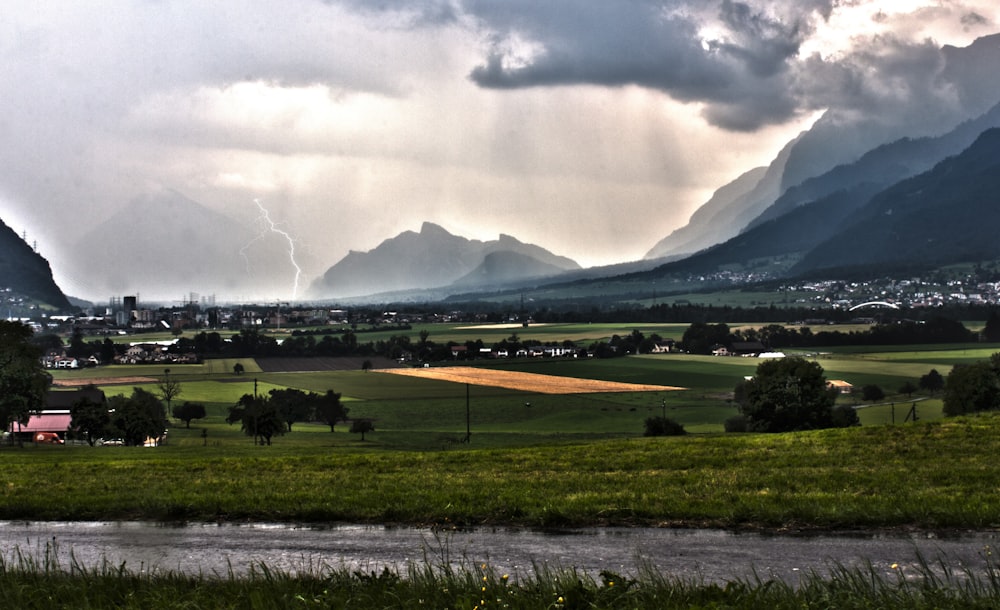 Lightning above the mountains in the surroundings of a small city.