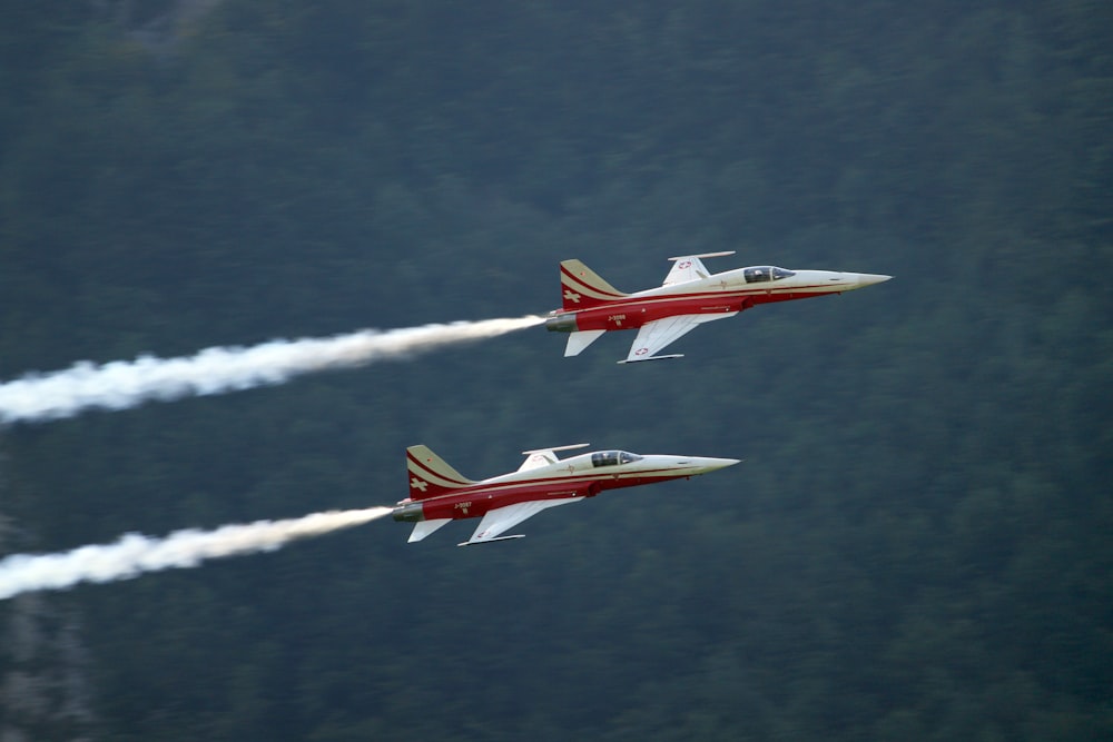 two red-and-white jet planes on air