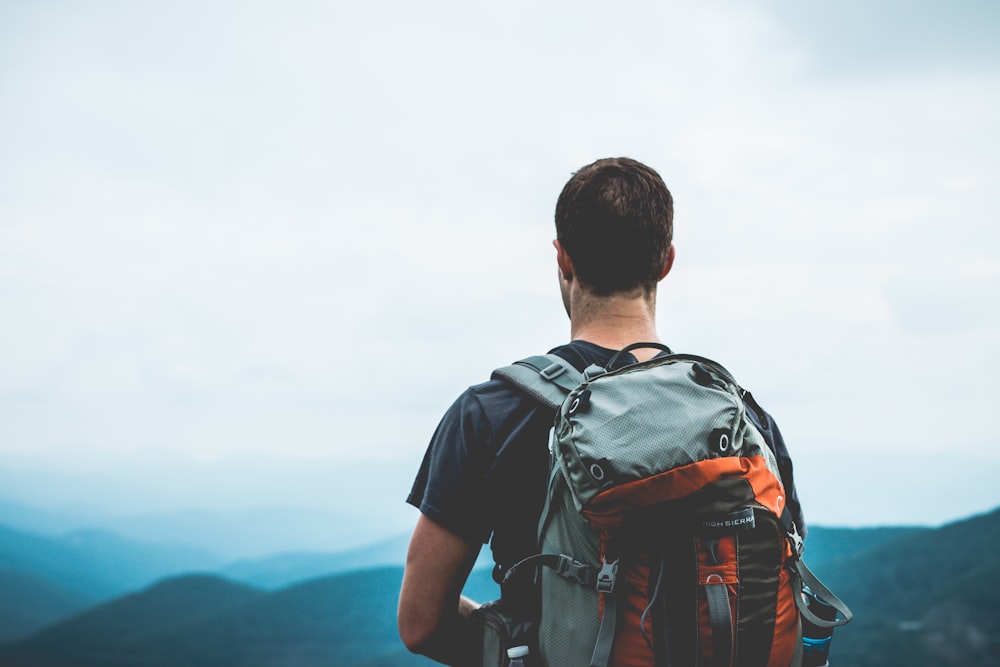 man carrying hiking bag outdoors