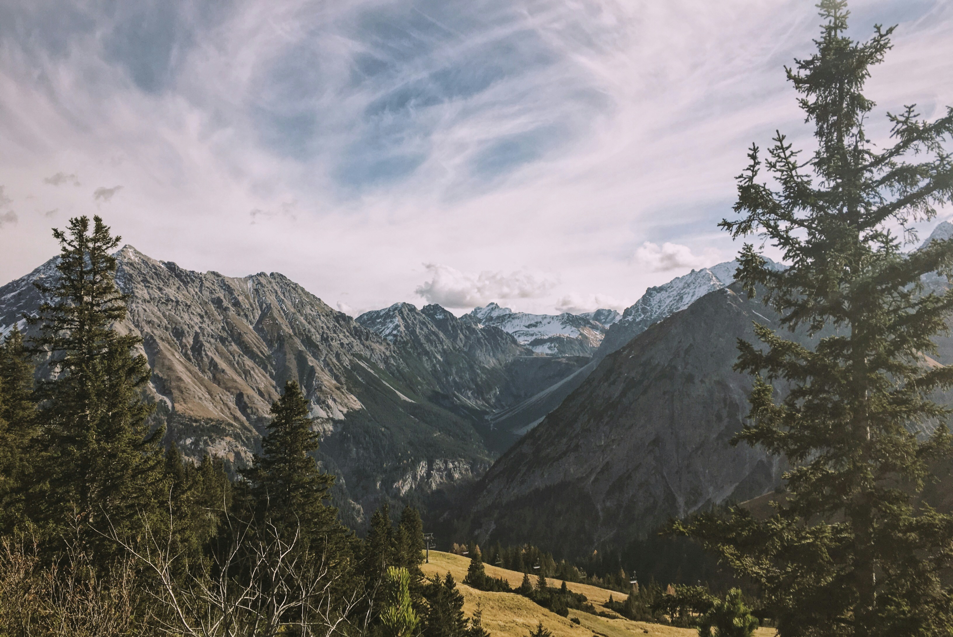 ice capped fault-block mountain under cumulus clouds nature photography, 