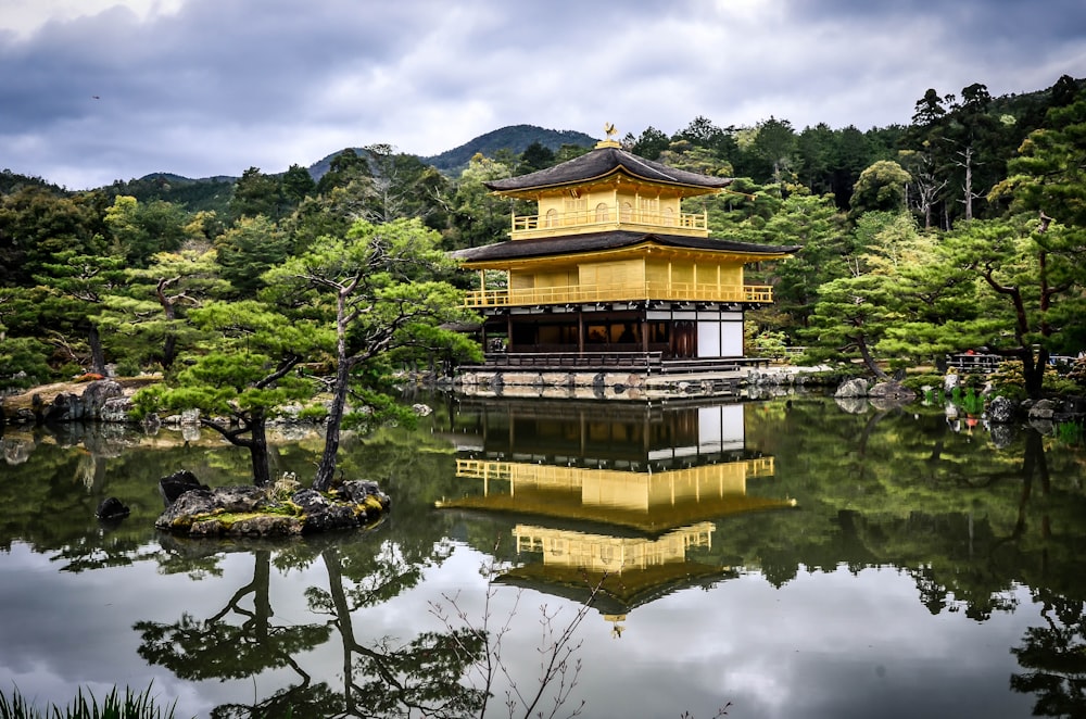 black and brown 3-layer gazebo in middle of water