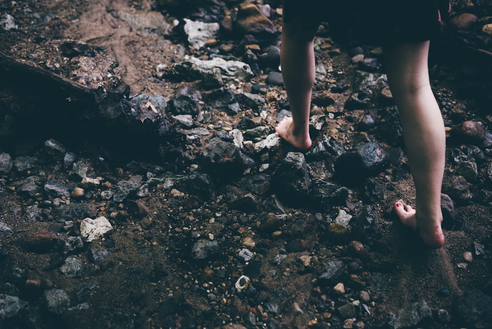 person walking on rocky grounds