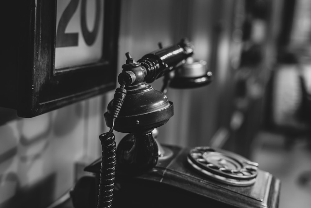 candlestick telephone in monochrome photo