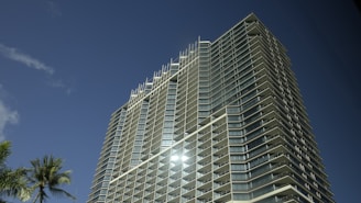 A modern condo building with balconies overlooking a bustling Florida cityscape.